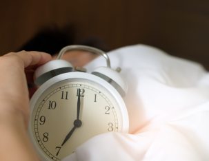 Canva Photo of Person Holding Alarm Clock scaled 303x234